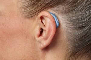 Oticon intent hearing aid worn behind the ear